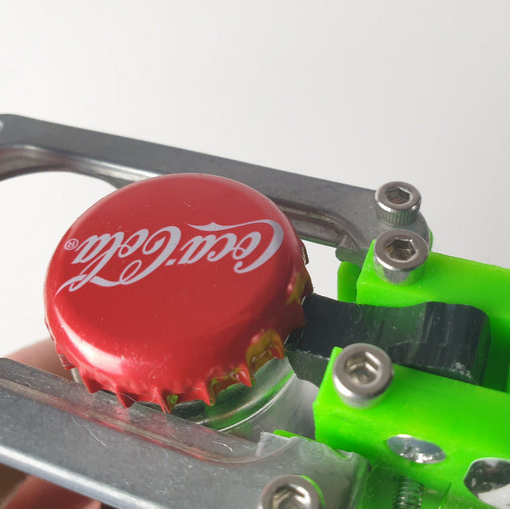 Bottle cap being removed from a Coca-Cola bottle using a green and silver bottle opener.